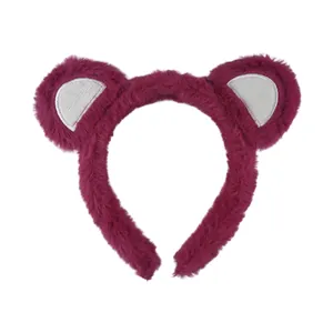 Close-up of soft berry-colored plush animal ear headband with fluffy faux fur texture