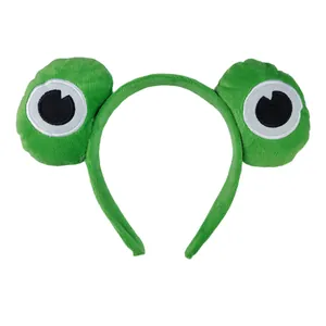 Detail of soft green plush frog headband with cartoon eyes for skincare and makeup