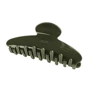 Detail of olive green acetate hair claw clip with Barrette La France gold lettering
