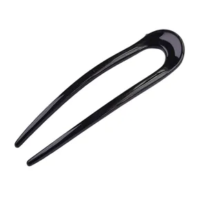 Minimalist black U-shaped hair pin for buns and updos with a glossy finish
