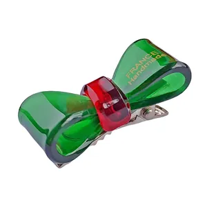 Pince à cheveux noeud en acétate vert faite main avec détail rouge et clip en métal
