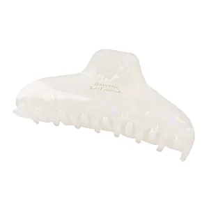 Detail of white pearlescent acetate hair claw clip with Barrette La France text