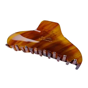 Close-up of tortoiseshell acetate hair claw clip with golden Barrette La France text