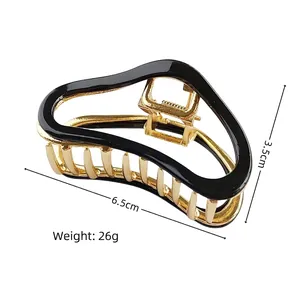 Pince à cheveux élégante en métal doré avec design en émail noir longueur de 6,5 cm