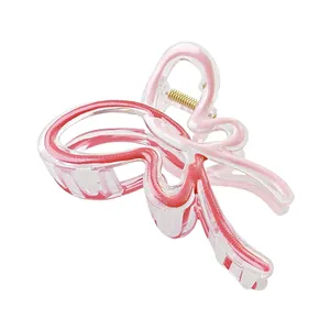 Large gradient butterfly hair claw clip with pink glitter outlines and gold metal spring