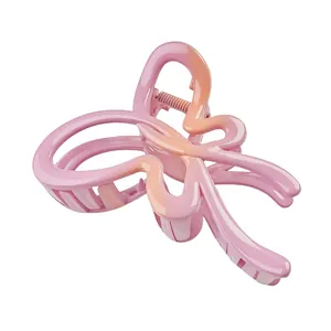 Detail view of pink and orange gradient butterfly hair claw clip with glossy finish