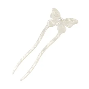 Detail of butterfly acetate U-shaped hair pin with elegant pearl center and pearly texture