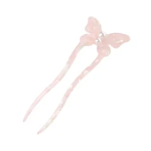 Macro detail of U-shaped hair pin featuring acetate butterfly and faux pearls