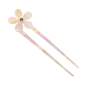Detail of five-petal flower U-shaped hairpin with acetate texture and purple rhinestone