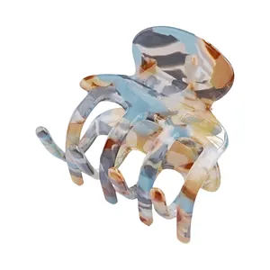 Elegant marble acetate hair claw clip for women in blue and beige with French handmade detail