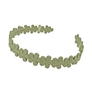 Detailed macro view of olive green matte flower headband with non-slip daisy petal design