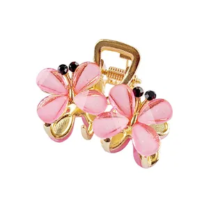 Molla per capelli dorata con farfalle di strass rosa sfumato per acconciature