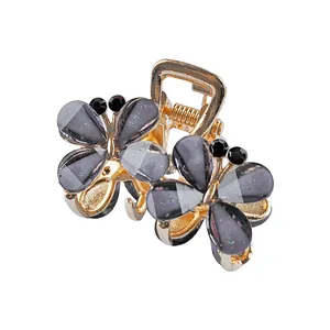 Elegante molletta per capelli a farfalla dorata con strass grigi per coda di cavallo