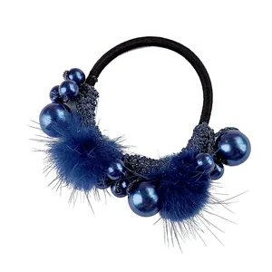 Elastic dark blue hair tie with plush pom poms, pearl beads and sparkling knit details