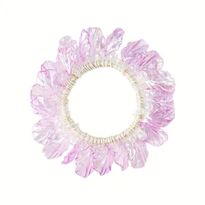 Elastic hair tie with purple iridescent petals and white pearl accents for ponytails