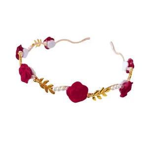 Detail of red rose floral headband with white pearls and golden metallic leaf ornaments
