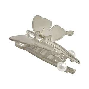 Close-up of translucent grey butterfly hair claw clip with white pearl accents