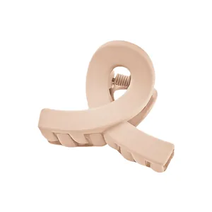 Detailed view of large matte nude pink crossover hair claw clip with strong spring