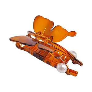 Elegant amber butterfly hair claw clip with pearls and transparent resin finish for women