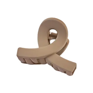 Matte milk tea color cross-knot hair claw clip for women made of durable material