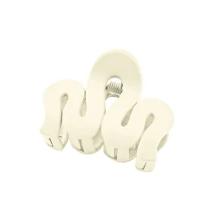 Close-up of cream wavy hair claw clip with glossy finish and durable metal spring
