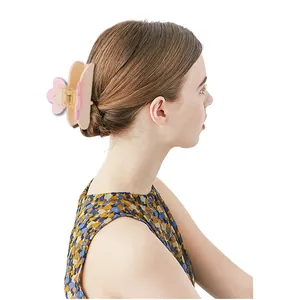 Pink and white flower hair claw clip shown on model for elegant daily hairstyle styling