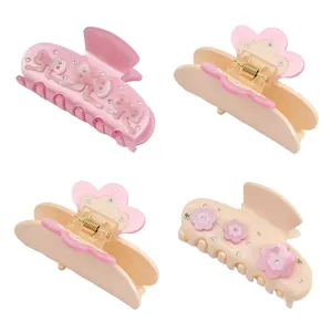 Bow and flower design acetate hair claws with rhinestones in pink and cream beige tones