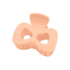 Matte peach pink bow-shaped hair claw clip with cross teeth for women hair styling