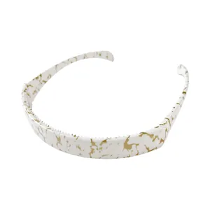Detail of white and gold marble patterned headband with non-slip inner teeth