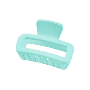 Detail view of mint green matte hollow rectangular hair claw clip with wide teeth for hair