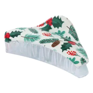 Close-up of large hair claw clip with Christmas holly leaves and berries print