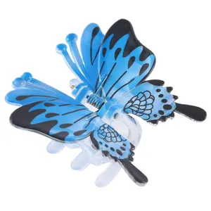 Detail of blue and black butterfly hair claw with transparent base and metal spring