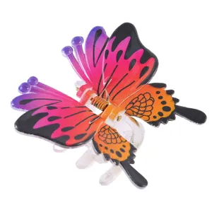 Detail of gradient butterfly hair claw clip with colorful wings and metal spring