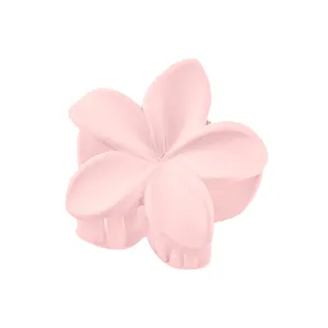 Detail view of pink frangipani hair claw clip with matte finish and secure grip teeth