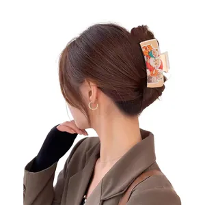 Christmas themed rectangular hair claw clip with colorful cat and dog prints on model