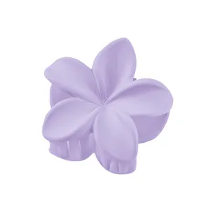 Macro detail of lavender matte plumeria flower hair claw clip with firm grip teeth