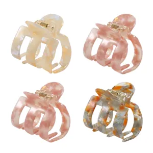 Set di quattro mollette per capelli in acetato con trama marmorizzata in rosa e crema