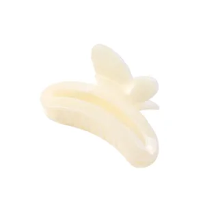 Detail of a creamy white butterfly hair claw clip with a pearlescent finish and smooth edges