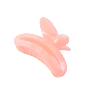 Close-up of translucent pink butterfly hair claw clip with cutout wings on white background