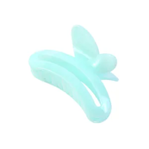 Detail of mint green butterfly hair claw clip with double-row teeth and metal spring