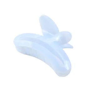 Macro detail of a light blue translucent butterfly hair claw clip with hollow cloud pattern