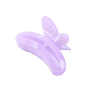 Macro detail of lavender butterfly hair claw clip with glossy resin finish and spring