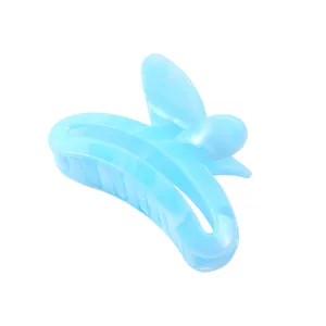 Close-up of translucent light blue butterfly hair claw clip with a marble texture finish