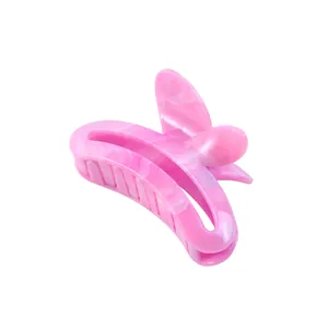 Detail view of pink marble pattern butterfly hair claw clip with acetate finish