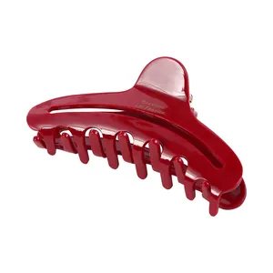 Glossy red crescent hair claw clip for women featuring 12 teeth and an ergonomic design
