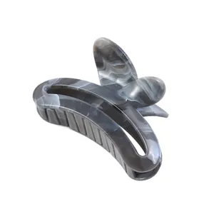 Detailed side view of a butterfly hair claw clip with marble grey acetate finish