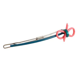 Close-up of a pink bow hair clip with dark blue accent and gold metal details