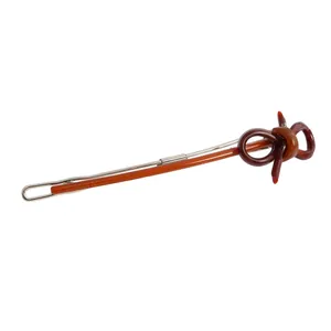 Detailed macro view of an amber brown resin bow hair clip with a silver metal base