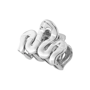 Detail of silver wavy claw clip showing polished metallic finish and hollow cloud design