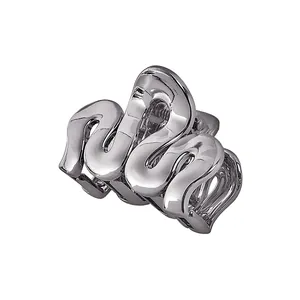 Detailed view of silver hollow cloud hair claw with polished wave lines and metal spring
